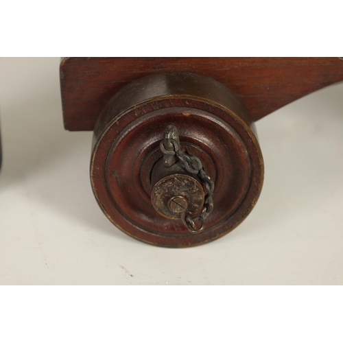 381 - AN 18TH/19TH CENTURY BRONZE STARTING CANNON with proof marks; mounted on an oak cutout carriage with... 