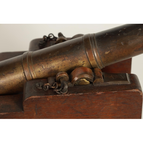 381 - AN 18TH/19TH CENTURY BRONZE STARTING CANNON with proof marks; mounted on an oak cutout carriage with... 