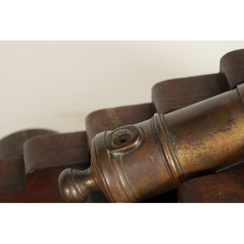 381 - AN 18TH/19TH CENTURY BRONZE STARTING CANNON with proof marks; mounted on an oak cutout carriage with... 