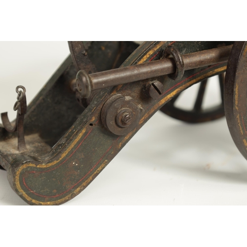 389 - A 19TH CENTURY BRONZE AND CAST IRON STARTING CANNON with painted and gilt high-lighted carriage fitt... 