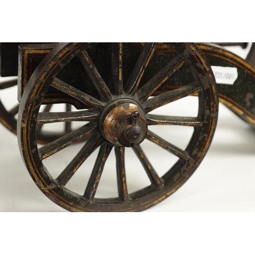 389 - A 19TH CENTURY BRONZE AND CAST IRON STARTING CANNON with painted and gilt high-lighted carriage fitt... 