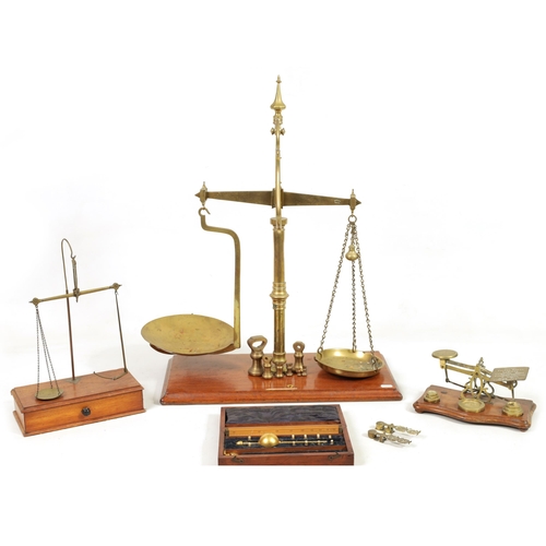 410 - A COLLECTION OF 19TH CENTURY WEIGHING SCALES the largest set of shop scales and bell weights labelle... 