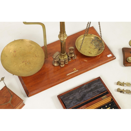 410 - A COLLECTION OF 19TH CENTURY WEIGHING SCALES the largest set of shop scales and bell weights labelle... 