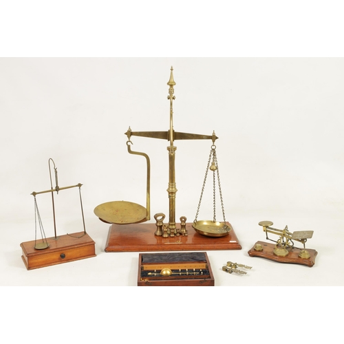 410 - A COLLECTION OF 19TH CENTURY WEIGHING SCALES the largest set of shop scales and bell weights labelle... 