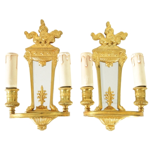 428 - A PAIR OF ORMOLU REGENCY STYLE TWO BRANCH WALL LIGHTS with tapering mirrored backs and ringed light ... 