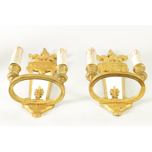 428 - A PAIR OF ORMOLU REGENCY STYLE TWO BRANCH WALL LIGHTS with tapering mirrored backs and ringed light ... 