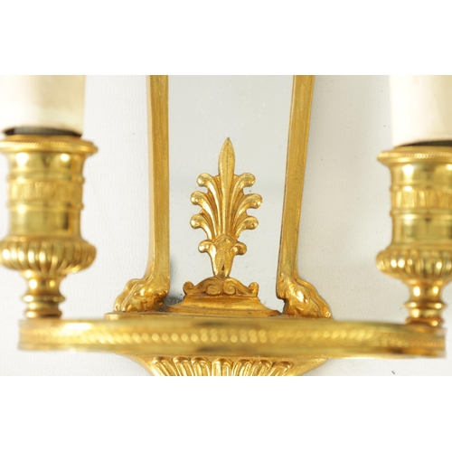 428 - A PAIR OF ORMOLU REGENCY STYLE TWO BRANCH WALL LIGHTS with tapering mirrored backs and ringed light ... 