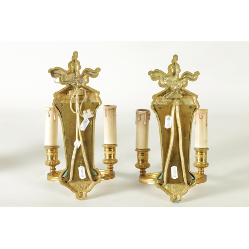 428 - A PAIR OF ORMOLU REGENCY STYLE TWO BRANCH WALL LIGHTS with tapering mirrored backs and ringed light ... 