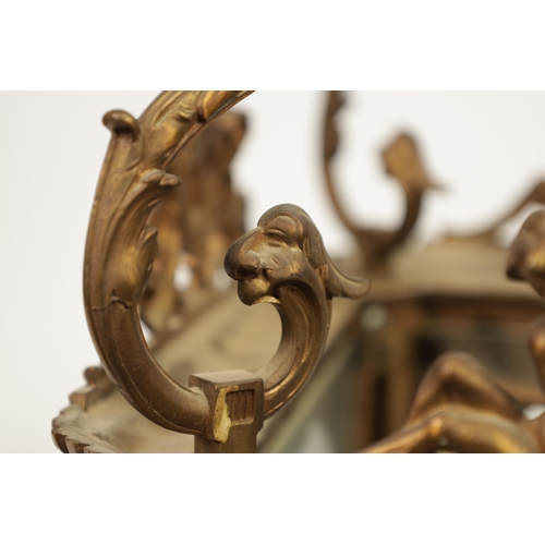 430 - A LATE 19TH CENTURY CAST BRASS HANGING LANTERN the arched glazed sides with mask head and caryatid c... 