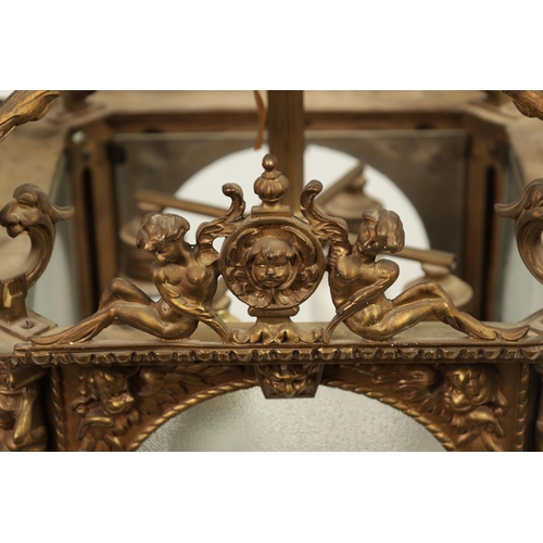 430 - A LATE 19TH CENTURY CAST BRASS HANGING LANTERN the arched glazed sides with mask head and caryatid c... 