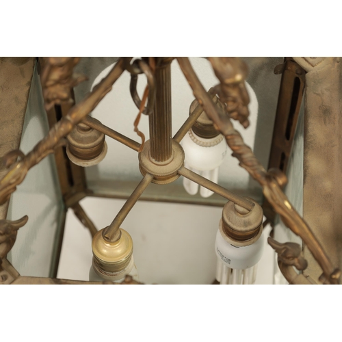 430 - A LATE 19TH CENTURY CAST BRASS HANGING LANTERN the arched glazed sides with mask head and caryatid c... 