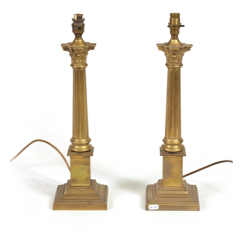 432 - A PAIR OF 20TH CENTURY GILT BRASS CORINTHIAN COLUMN TABLE LAMPS with square bases. (48cm high overal... 