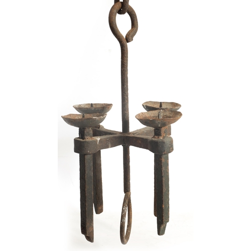 433 - A 19TH CENTURY CAST IRON HANGING CANDLE LIGHT having four pricket stick branches and hanging chain (... 