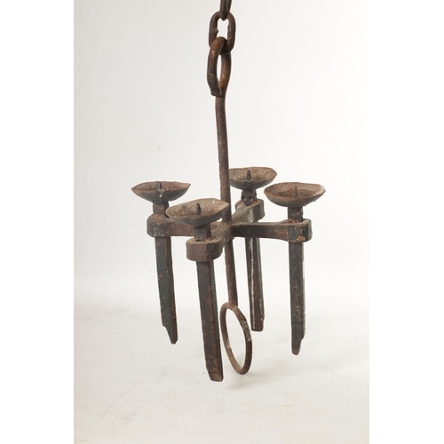 433 - A 19TH CENTURY CAST IRON HANGING CANDLE LIGHT having four pricket stick branches and hanging chain (... 