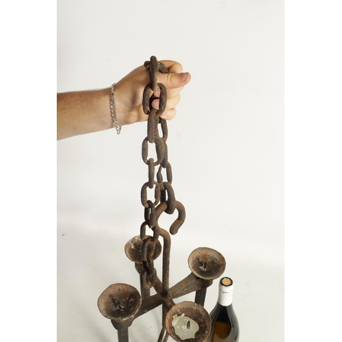 433 - A 19TH CENTURY CAST IRON HANGING CANDLE LIGHT having four pricket stick branches and hanging chain (... 