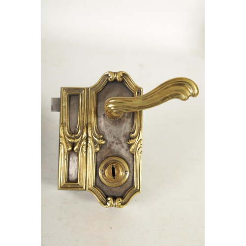 435 - A 19TH CENTURY FRENCH STEEL AND CAST BRASS MOUNTED DOOR LOCK of elaborate leaf cast Rococo design. (... 