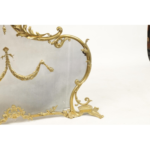 437 - A LATE 19TH CENTURY CAST BRASS FIRE SCREEN in the French Rococo style with meshwork front and centre... 