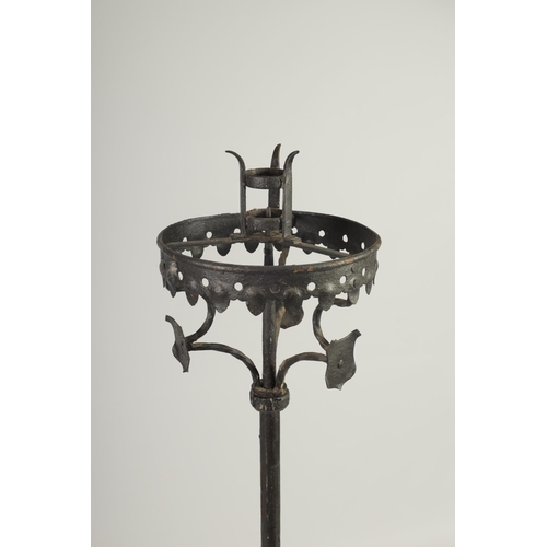 444 - A 17TH CENTURY CAST IRON STANDING PRICKET STICK with gothic style frieze above a knopped stem and tr... 