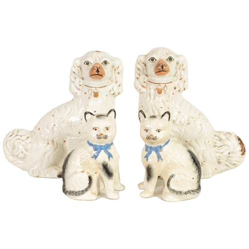 45 - A LARGE PAIR OF VICTORIAN SEATED STAFFORDSHIRE DOGS together with A PAIR OF SEATED MODELS OF CATS (3... 