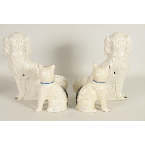 45 - A LARGE PAIR OF VICTORIAN SEATED STAFFORDSHIRE DOGS together with A PAIR OF SEATED MODELS OF CATS (3... 