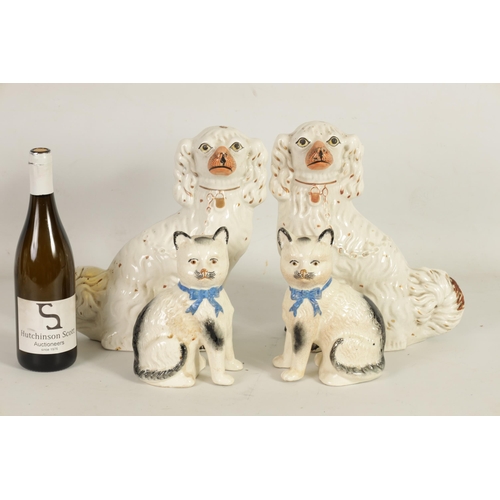 45 - A LARGE PAIR OF VICTORIAN SEATED STAFFORDSHIRE DOGS together with A PAIR OF SEATED MODELS OF CATS (3... 