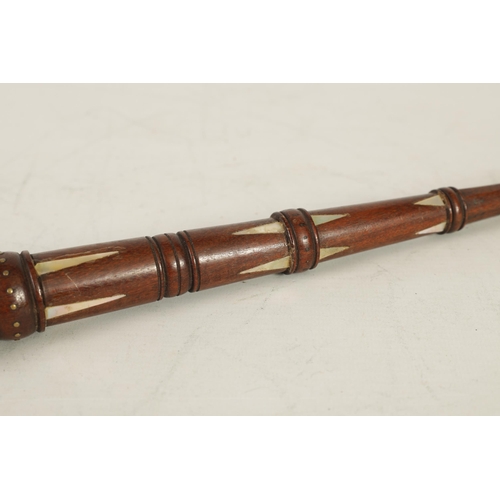 451 - A 19TH CENTURY MAHOGANY AND MOTHER OF PEARL INALID RIDING CROP with fist shaped handle and tapering ... 