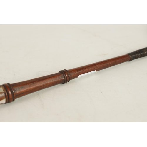 451 - A 19TH CENTURY MAHOGANY AND MOTHER OF PEARL INALID RIDING CROP with fist shaped handle and tapering ... 