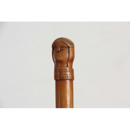 455 - AN EARLY 20TH CENTURY SCANDINAVIAN HARDWOOD WALKING STICK carved with a two-faced figural handle - p... 