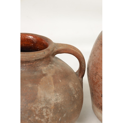 46 - TWO EARLY CONTINENTAL TERRACOTTA POTTERY JUGS one of squat bulbous shape with side handle the other ... 