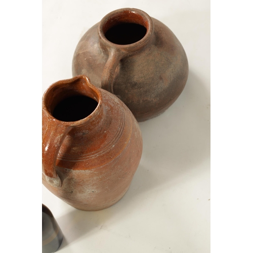 46 - TWO EARLY CONTINENTAL TERRACOTTA POTTERY JUGS one of squat bulbous shape with side handle the other ... 