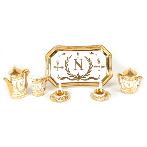 47 - AN EARLY 20TH CENTURY MINIATURE LIMOGES PORCELAIN FRENCH NAPOLEON TEA SERVICE comprising coffee can,... 