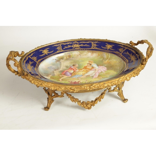 55 - A LATE 19TH CENTURY SERVES STYLE OVAL ORMOLU MOUNTED CENTREPIECE with a painted classical figure sce... 