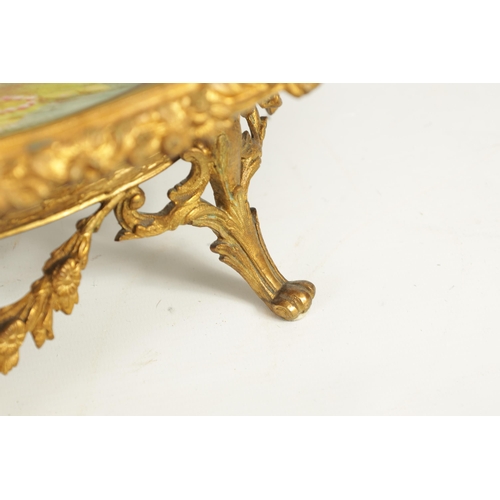 55 - A LATE 19TH CENTURY SERVES STYLE OVAL ORMOLU MOUNTED CENTREPIECE with a painted classical figure sce... 