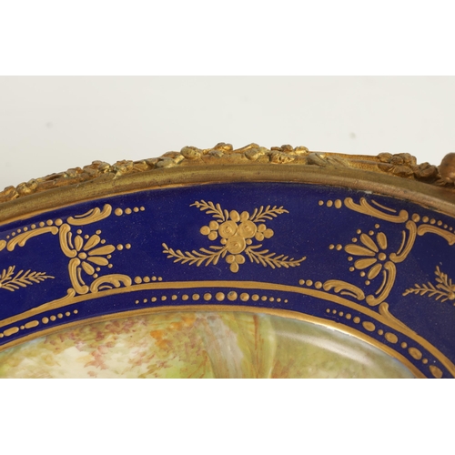 55 - A LATE 19TH CENTURY SERVES STYLE OVAL ORMOLU MOUNTED CENTREPIECE with a painted classical figure sce... 