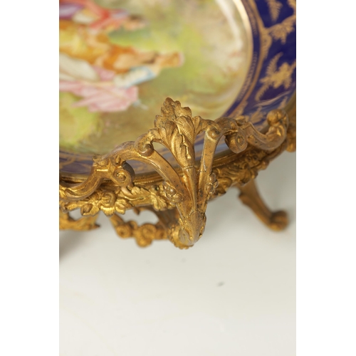 55 - A LATE 19TH CENTURY SERVES STYLE OVAL ORMOLU MOUNTED CENTREPIECE with a painted classical figure sce... 