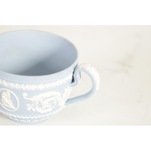 58 - A LATE 18TH CENTURY WEDGWOOD JASPERWARE CUP AND SAUCER decorated with classical figures and scrollin... 