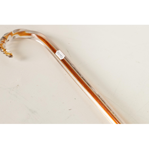 6 - A LATE 19TH CENTURY GLASS WALKING STICK of triangular form with amber cane centre and twisted handle... 