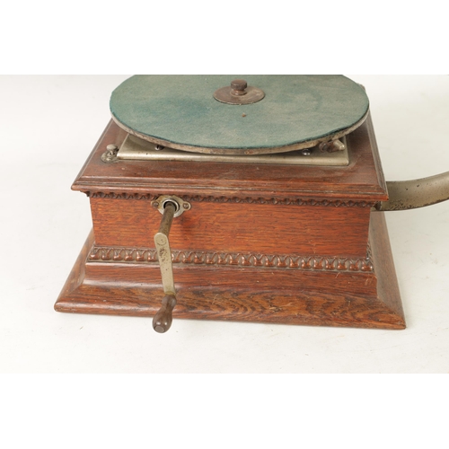 606 - AN EARLY 20TH CENTURY GRAMOPHONE BY THE GRAMOPHONE & TYPEWRITER COMPANY having an oak base with gold... 