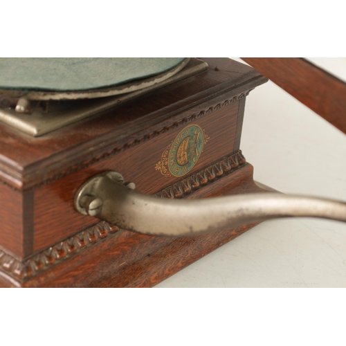 606 - AN EARLY 20TH CENTURY GRAMOPHONE BY THE GRAMOPHONE & TYPEWRITER COMPANY having an oak base with gold... 