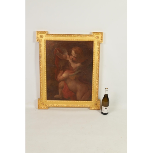 611 - A 17TH CENTURY STYLE FLEMISH SCHOOL OIL ON CANVAS DEPICTING TWO WINGED CHERUBS mounted in a gilt mou... 