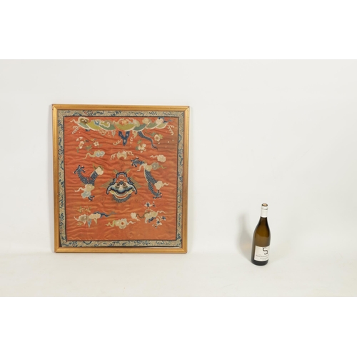 630 - A 19TH CENTURY CHINESE SILK TAPESTRY DEPICTING A DRAGON amongst clouds - glazed gilt frame. (65cm hi... 