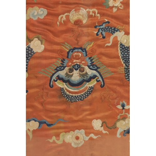 630 - A 19TH CENTURY CHINESE SILK TAPESTRY DEPICTING A DRAGON amongst clouds - glazed gilt frame. (65cm hi... 