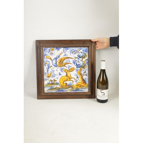 64 - A 19TH CENTURY PORTUGUESE CERAMIC TILE polychrome coloured depicting a rabbit and bird in a landscap... 