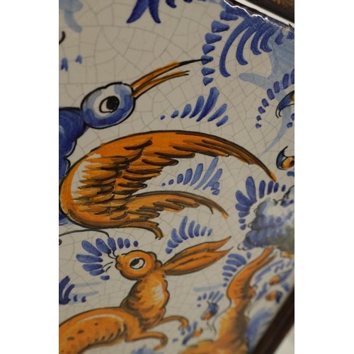 64 - A 19TH CENTURY PORTUGUESE CERAMIC TILE polychrome coloured depicting a rabbit and bird in a landscap... 