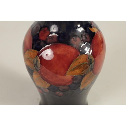 70 - A WILLIAM MOORCROFT POMEGRANATE PATTERN MOORCROFT VASE Circa 1930's of inverted baluster form tube l... 