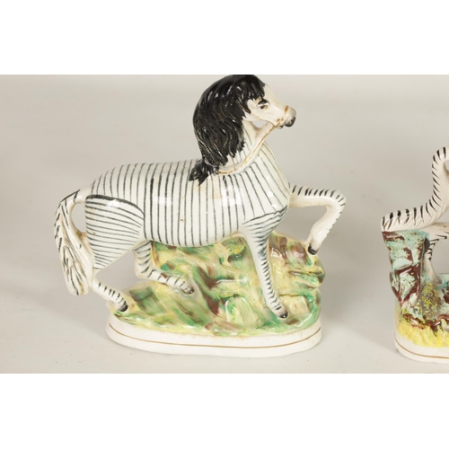 74 - A PAIR OF 19TH-CENTURY STAFFORDSHIRE ZEBRAS AND A SIMILAR LARGER EXAMPLE (26.5cm and 22cm high, 16.5... 