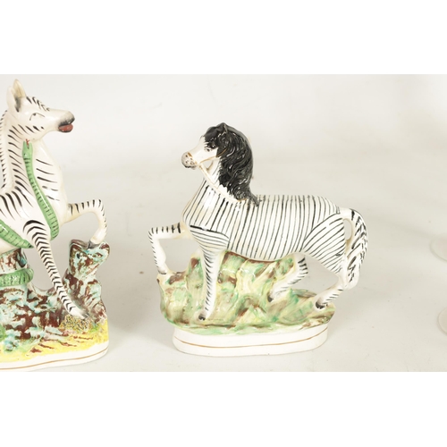 74 - A PAIR OF 19TH-CENTURY STAFFORDSHIRE ZEBRAS AND A SIMILAR LARGER EXAMPLE (26.5cm and 22cm high, 16.5... 