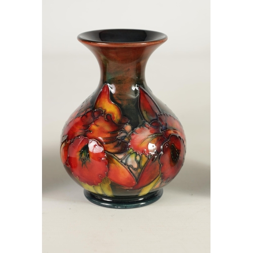 86 - TWO MOORCROFT FLAMBÉ WARE CABINET VASES the 1930's small shouldered tapering Vase tube lined and dec... 