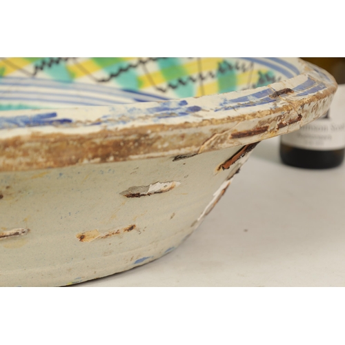 87 - A LARGE EARLY SPANISH LEBRILLO CERAMIC CHARGER decorated with polychrome coloured decoration depicti... 