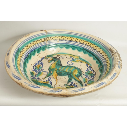 97 - A 17TH CENTURY SPANISH TERRACOTTA CHARGER decorated in polychrome colours depicting a horse. (65cm d... 